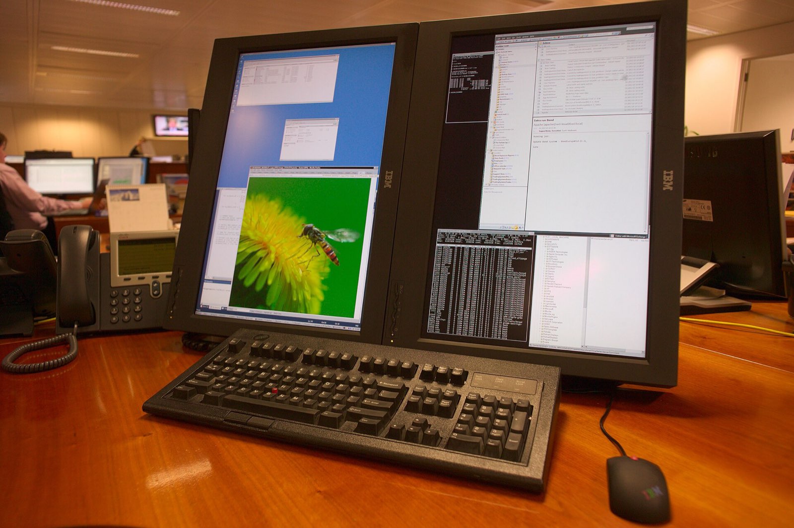 My desk at work. Two T221s rotated 90 degrees, M13 keyboard, IBM/Lenovo mouse.