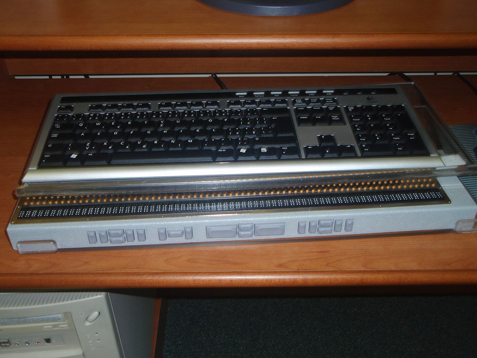 A refreshable braille display showing a line of braille cells.