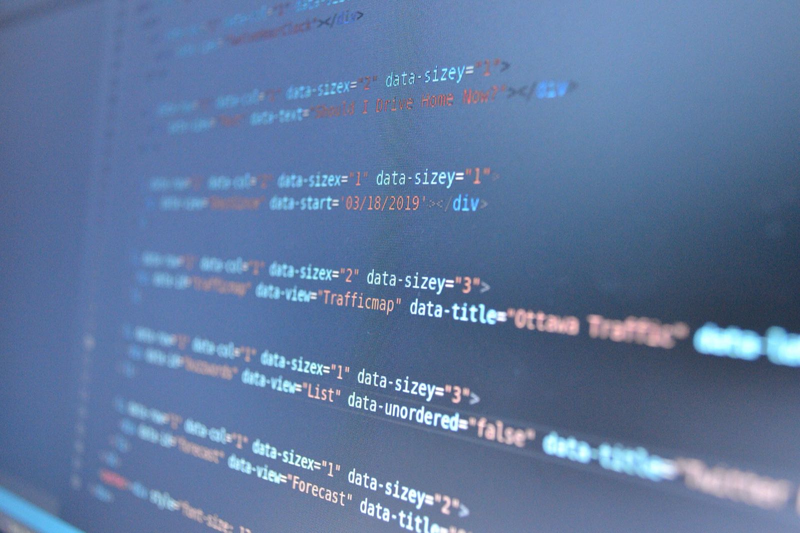 A close-up of computer code, deliberately blurred.